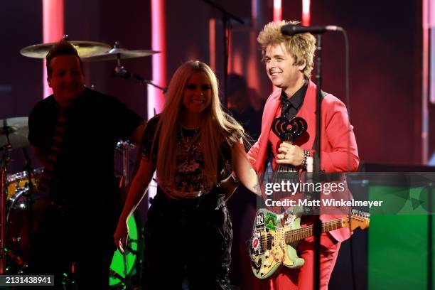 Tré Cool and Billie Joe Armstrong of Green Day accept the Landmark Award from Avril Lavigne onstage during the 2024 iHeartRadio Music Awards at Dolby...