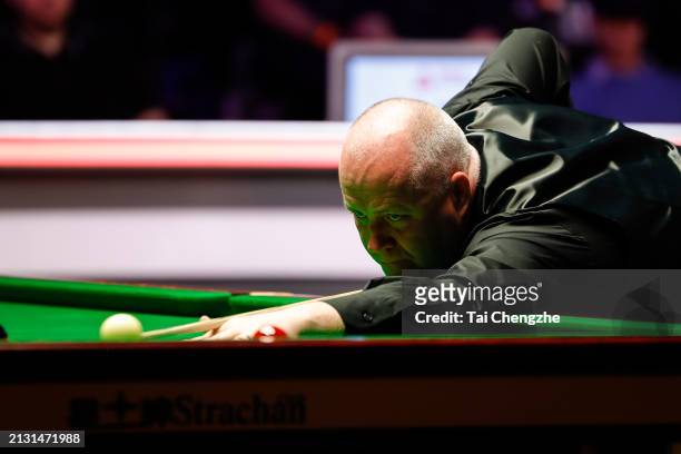 John Higgins of Scotland plays a shot in the first round match against Mark Allen of Northern Ireland on day one of 2024 Johnstone's Paint Tour...