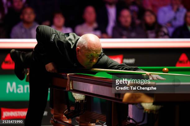 John Higgins of Scotland plays a shot in the first round match against Mark Allen of Northern Ireland on day one of 2024 Johnstone's Paint Tour...