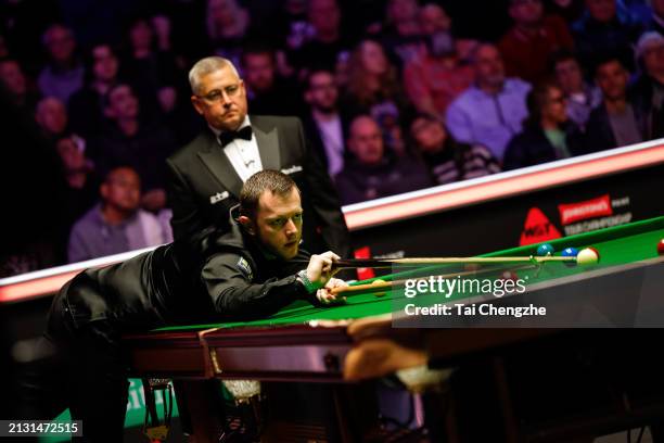 Mark Allen of Northern Ireland plays a shot in the first round match against John Higgins of Scotland on day one of 2024 Johnstone's Paint Tour...