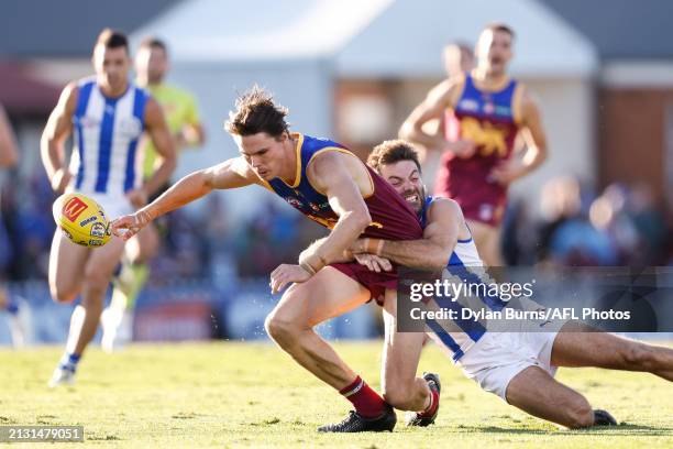 Eric Hipwood of the Lions is tackled by Luke McDonald of the Kangaroos during the 2024 AFL Round 04 match between the Brisbane Lions and the North...