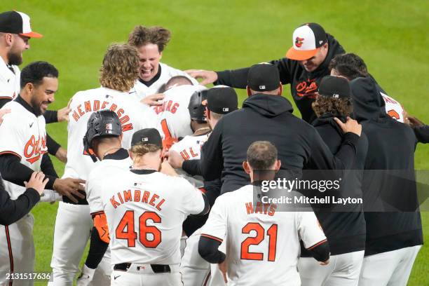 Jordan Westburg of the Baltimore Orioles celebrates hitting a walk off home run in the ninth inning with teammates during a baseball game against the...
