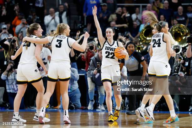 Caitlin Clark of the Iowa Hawkeyes and her teammates celebrate after beating the LSU Tigers 94-87 in the Elite 8 round of the NCAA Women's Basketball...