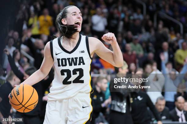 Caitlin Clark of the Iowa Hawkeyes celebrates after beating the LSU Tigers 94-47 in the Elite 8 round of the NCAA Women's Basketball Tournament at...