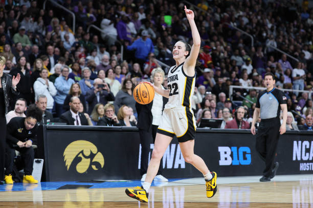Caitlin Clark of the Iowa Hawkeyes celebrates after beating the LSU Tigers 94-87 in the Elite 8 round of the NCAA Women's Basketball Tournament at...