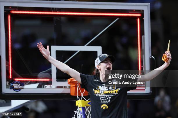 Caitlin Clark of the Iowa Hawkeyes cuts down the net after beating the LSU Tigers 94-87 in the Elite 8 round of the NCAA Women's Basketball...