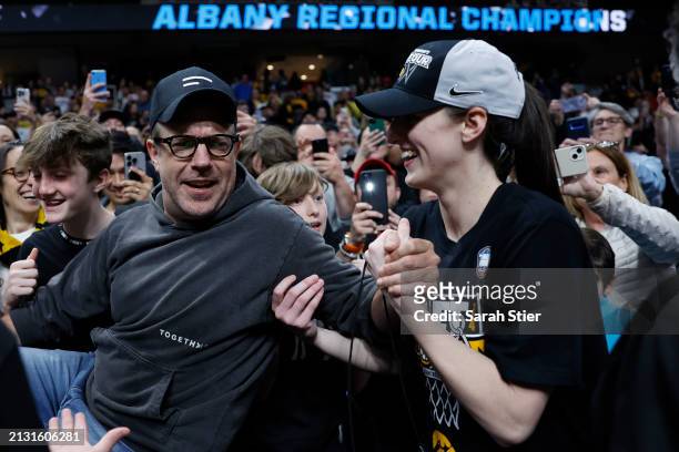 Caitlin Clark of the Iowa Hawkeyes celebrates with Jason Sudeikis after the Iowa Hawkeyes beat the LSU Tigers 94-87 in the Elite 8 round of the NCAA...