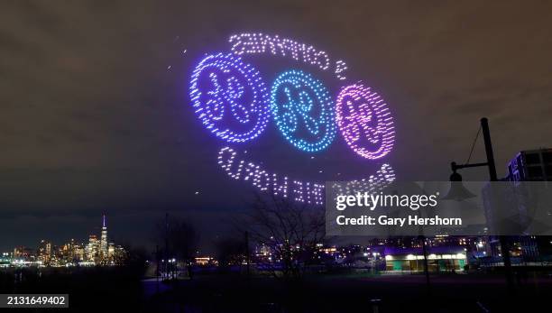 Drone show sponsored by General Electric lights up in front of lower Manhattan and One World Trade Center in New York City on April 1 in Weehawken,...