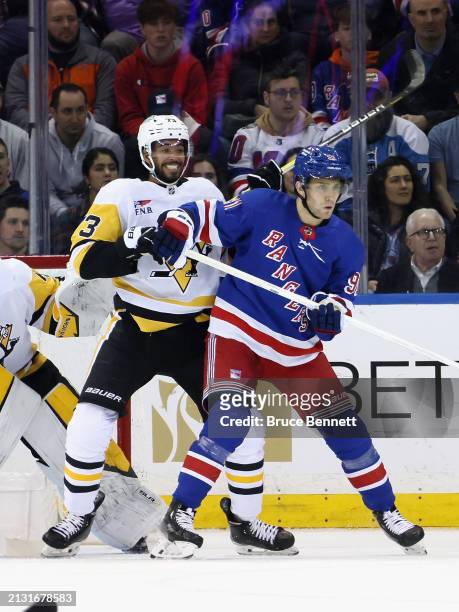 Pierre-Olivier Joseph of the Pittsburgh Penguins checks Alex Wennberg of the New York Rangers at Madison Square Garden on April 01, 2024 in New York...
