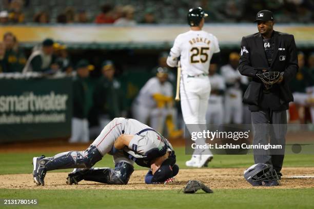 Catcher Reese McGuire of the Boston Red Sox reacts after being hit by a pitch in the bottom of the seventh inning against the Oakland Athletics at...