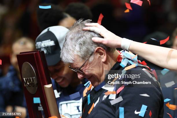 Head coach Geno Auriemma of the Connecticut Huskies reacts after getting covered in confetti after his team's 80-73 win against the USC Trojans in...