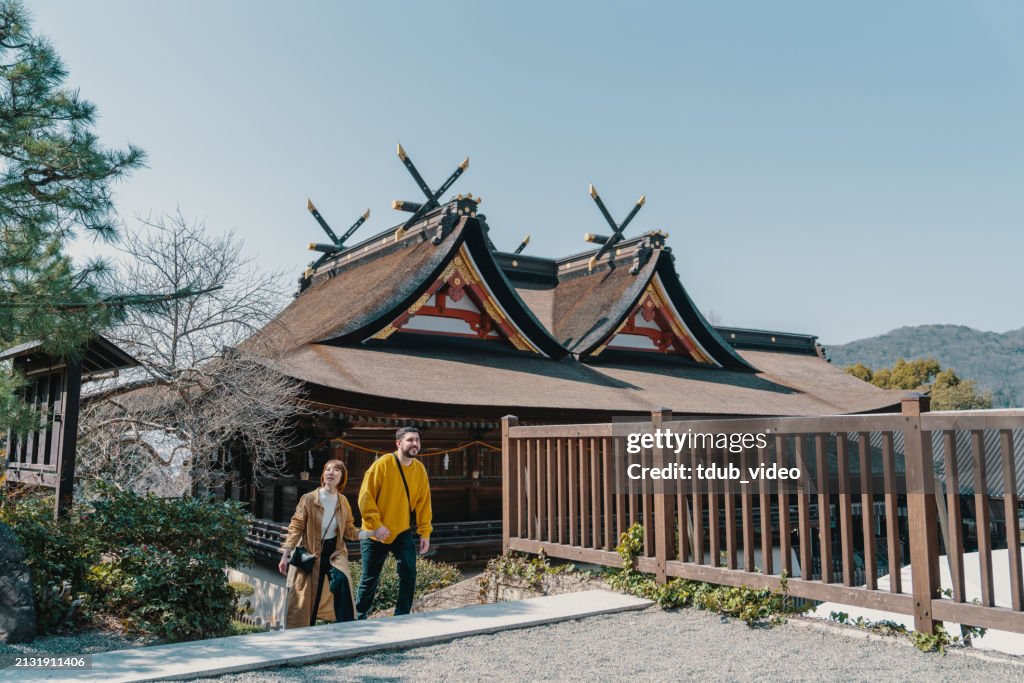 Married couple of mixed ethnicity visiting a Japanese shrine