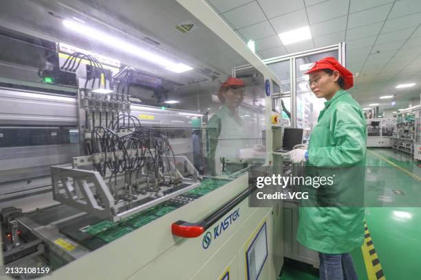 An employee works on the production line of smart electric meters at a workshop of the Hangzhou Xili Intelligent Technology Co., Ltd. On April 2,...