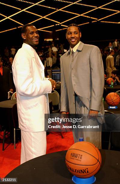 LeBron James and Carmelo Anthony look on during the 2003 NBA Draft at the Paramount Theatre at Madison Square Garden on June 26, 2003 in New York,...