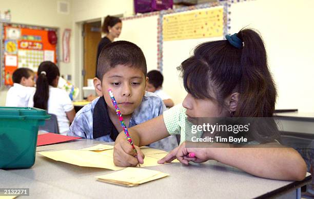 Students work together in teacher Daisy Moran's second-grade bilingual class during summer school at Mozart School July 2, 2003 in Chicago, Illinois....