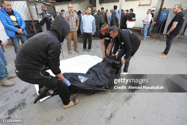 People look emotional as they receive the bodies of World Central Kitchen workers who were killed by Israeli air strikes on April 02, 2024 in Rafah,...