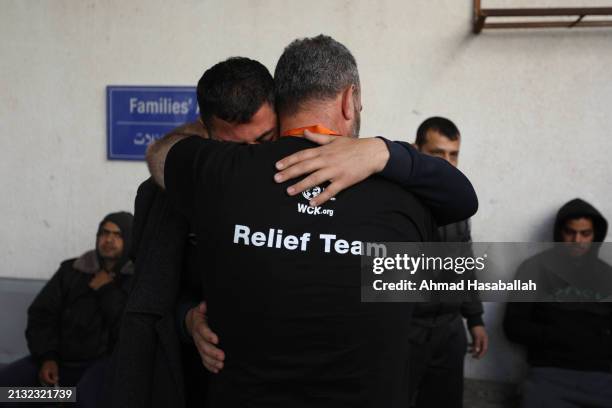 Two men become emotional and comfort each other as they receive the bodies of World Central Kitchen workers who were killed by Israeli air strikes on...