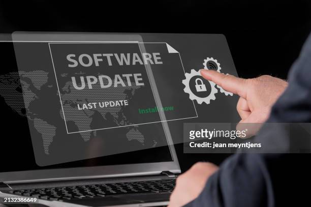 update in progress: enhancing cybersecurity measures. a person activates a software update on the virtual screen of a laptop to ensure the latest security - security screen icons stock pictures, royalty-free photos & images