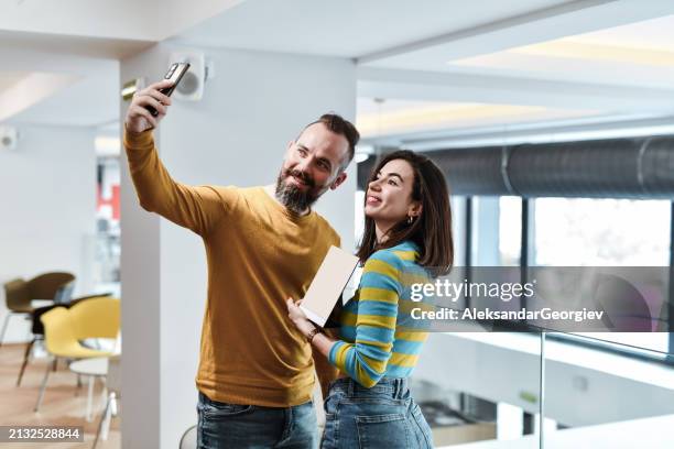 smiling designer couple taking selfie with their new award - the inspiration awards for women inside stock pictures, royalty-free photos & images