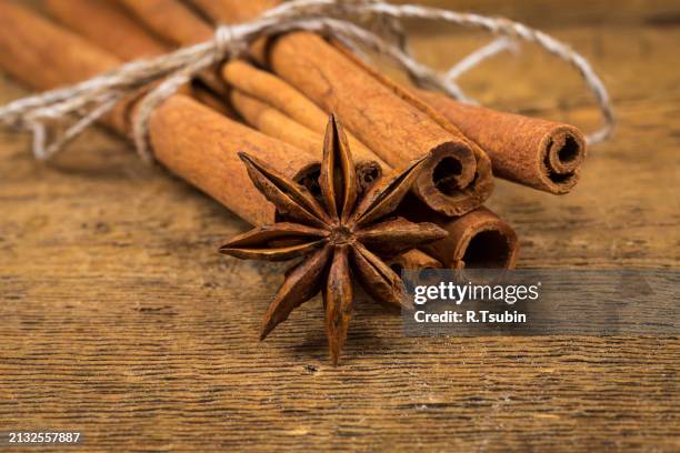 close up of cinnamon sticks and star anise on wood - rustic star stock pictures, royalty-free photos & images