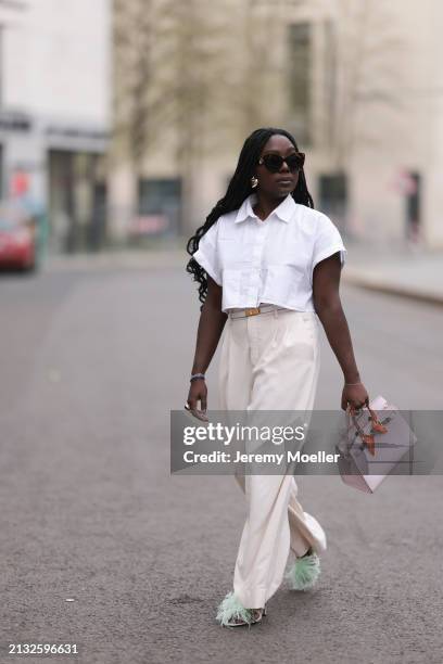 Lois Opoku seen wearing Julian Daynov x Rossi beige suit pants, Hermes Kelly white leather yellow gold belt, Zara white blouse, Hermes beige and rosé...