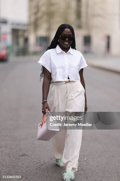 Lois Opoku seen wearing Julian Daynov x Rossi beige suit pants, Hermes Kelly white leather yellow gold belt, Zara white blouse, Hermes beige and rosé...