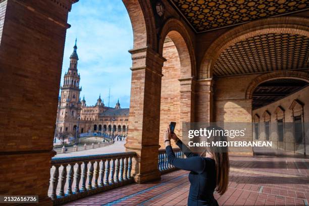 tourist brunette young woman selfie photo, seville plaza de espana square in andalusia spain - andalucía de moda stock-fotos und bilder