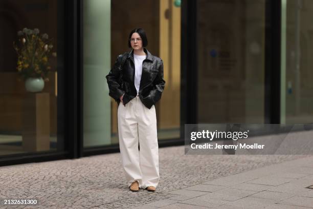 Maria Barteczko seen wearing Ray-Ban gold round retro glasses, Source Unknown black woven leather jacket, Arket white cotton basic t-shirt, Source...