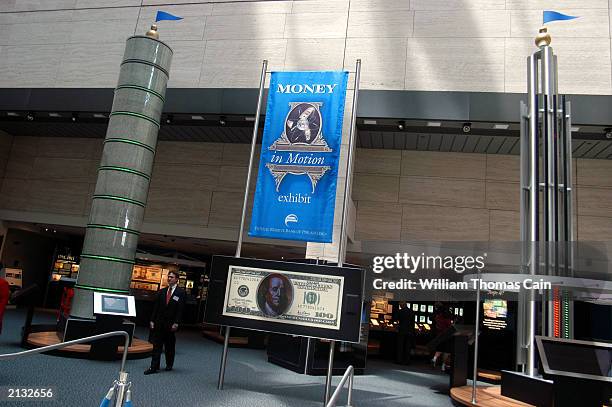 Toursist walks through the "Money in Motion" exhibit at the Philadelphia Federal Reserve Bank July 2, 2003 in Philadelphia, Pennsylvania. "Money in...