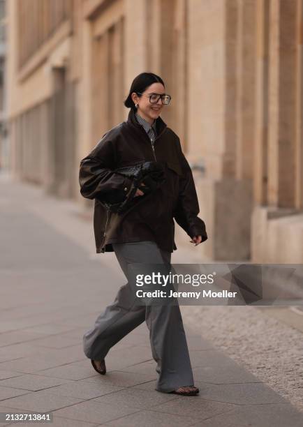 Maria Barteczko seen wearing Victoria Beckham black oversized Aviator glasses, The Frankie Shop brown leather windbreaker / bomber leather jacket,...