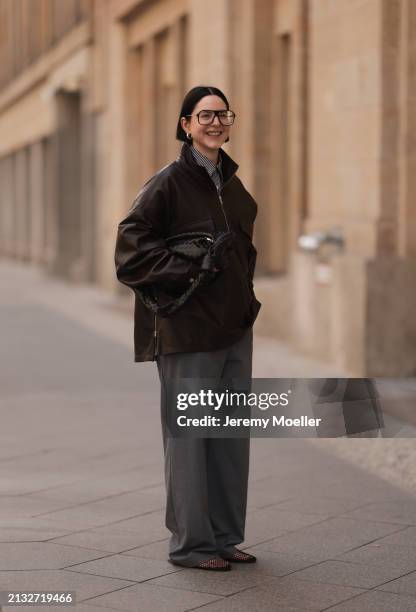 Maria Barteczko seen wearing Victoria Beckham black oversized Aviator glasses, The Frankie Shop brown leather windbreaker / bomber leather jacket,...