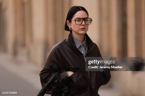 Maria Barteczko seen wearing Victoria Beckham black oversized Aviator glasses, The Frankie Shop brown leather windbreaker / bomber leather jacket,...