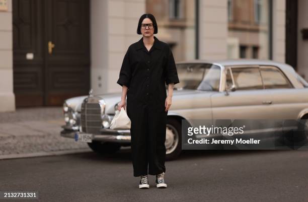 Maria Barteczko seen wearing Victoria Beckham black oversized Aviator glasses, WENDYKEI black cotton overall jumpsuit, white woven bag with Prada...