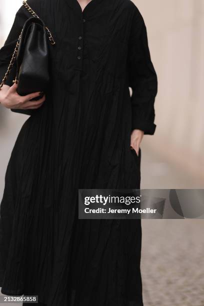 Maria Barteczko seen wearing WENDYKEI black wrinkled oversized midi dress and Chanel black classic leather flap bag, on March 31, 2024 in Berlin,...