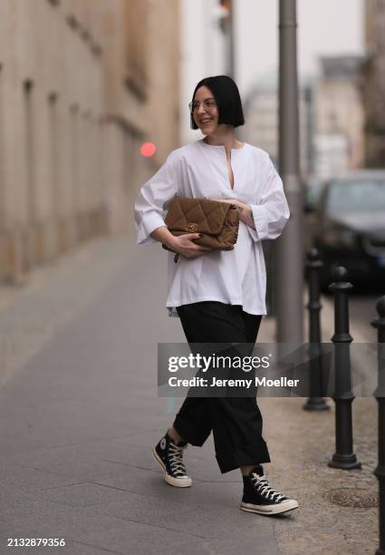 Maria Barteczko seen wearing Ray-Ban gold round retro glasses, WENDYKEI white cotton oversized buttoned shirt, WENDYKEI black pinstriped culotte...