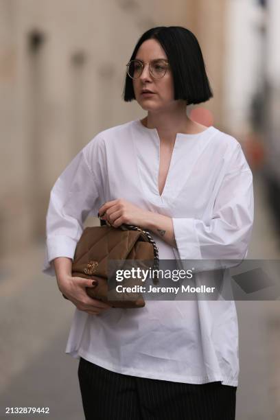 Maria Barteczko seen wearing Ray-Ban gold round retro glasses, WENDYKEI white cotton oversized shirt, WENDYKEI black pinstriped culotte pants, Chanel...