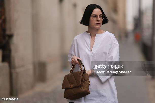 Maria Barteczko seen wearing Ray-Ban gold round retro glasses, WENDYKEI white cotton oversized shirt and Chanel 19 beige quilted canvas flap bag, on...