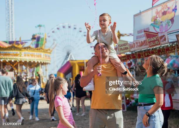 family fun at the funfair - person holding a balloon stock pictures, royalty-free photos & images