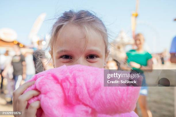 peeking out behind her candy floss - sockervadd bildbanksfoton och bilder