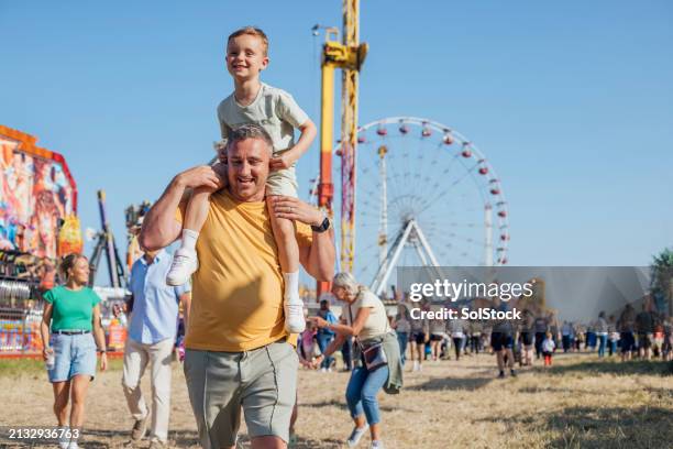exploring the travelling carnival - family day stock pictures, royalty-free photos & images