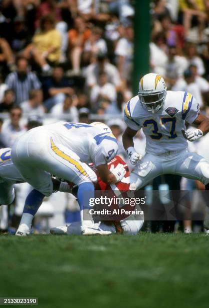 Free Safety Eric Castle and Strong Safety Rodney Harrison of the San Diego Chargers make a stop in the Pro Football Hall of Fame game between the San...