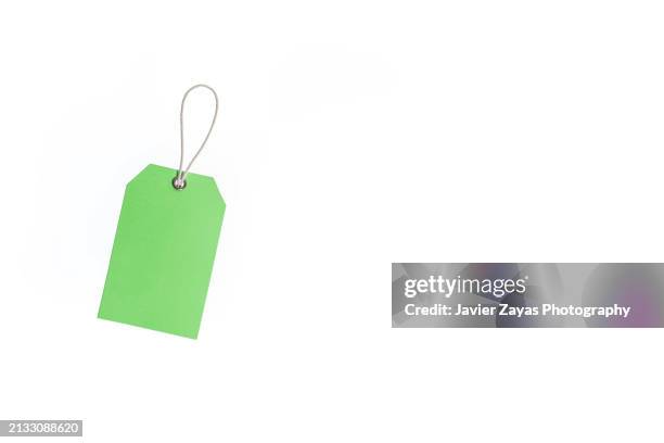 green paper price label with rope isolated on white - prislapp bildbanksfoton och bilder