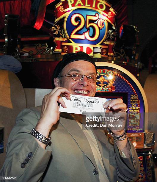 Actor Joe Pantoliano shows off his slot winnings of $9.00 at the opening of the Borgata Hotel Casino & SPA on July 3, 2003 in Atlantic City, New...