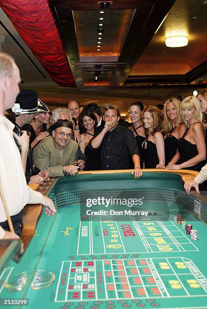 Actor David Arquette and actor Joe Pantoliano watch as actor Stephen Dorff blows on a pair of dice before throwing the 1st roll at the opening of the...