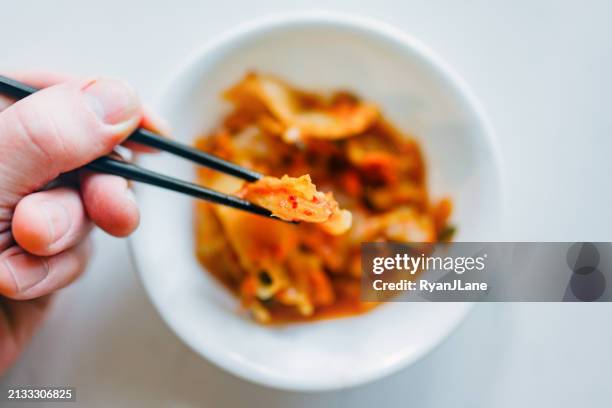authentic homemade kimchi - person eating bowl of chili stock pictures, royalty-free photos & images