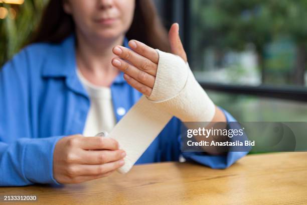 closeup photography of woman hands,using elastic bandage from pain in joint. - ace bandage stock pictures, royalty-free photos & images