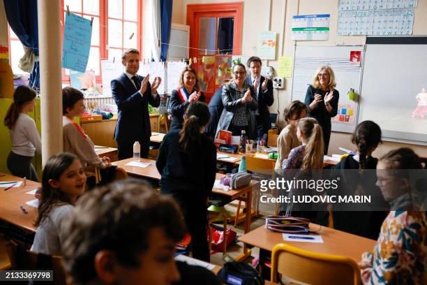 French President Emmanuel Macron , France's Minister for Education and Youth Nicole Belloubet , France's Deputy Minister for the Elderly and the...