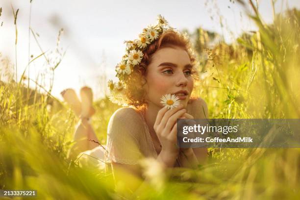 beautiful woman lying down on the grass - diadem stock pictures, royalty-free photos & images