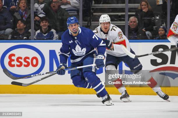 Niko Mikkola of the Florida Panthers skates against Ryan Reaves of the Toronto Maple Leafs during the first period in an NHL game at Scotiabank Arena...