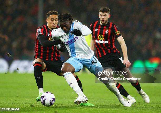 Eberechi Eze of Crystal Palace is challenged by Marcus Tavernier and Ryan Christie of AFC Bournemouth during the Premier League match between AFC...